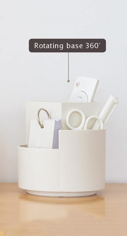 White cylindrical container with stationery items on a wooden surface, featuring a rotating base 360° label.