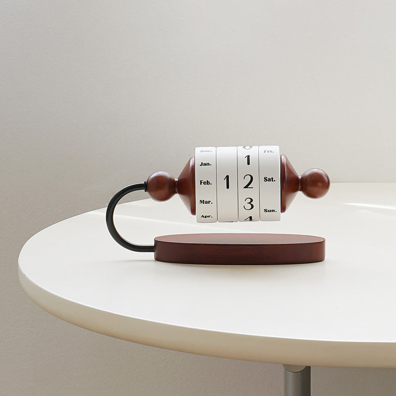 Perpetual calendar with wooden roll on a white surface